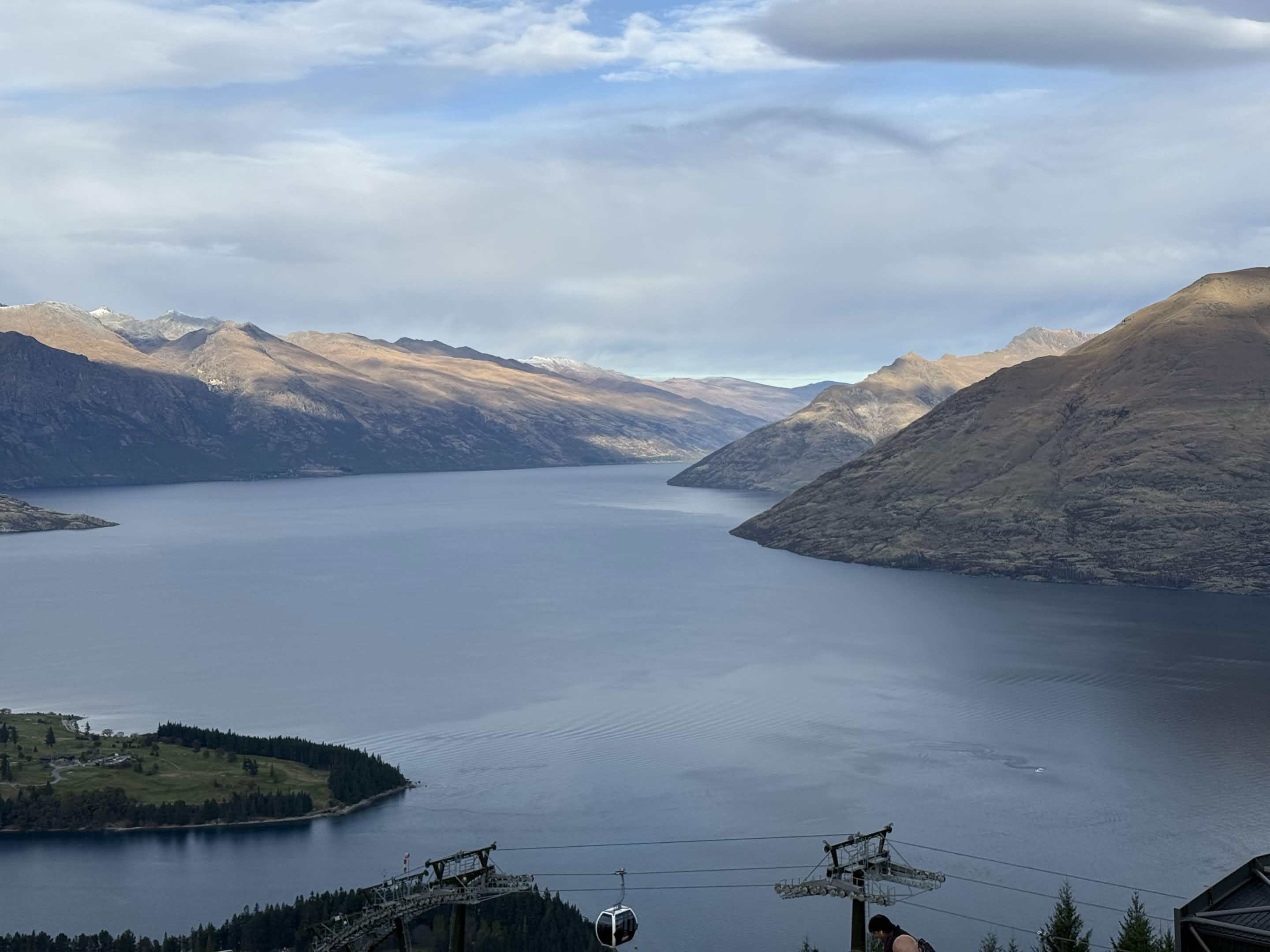 Lake Wakatipu ringed by golden mountains, seen from the Skyline Gondola cables above Queenstown